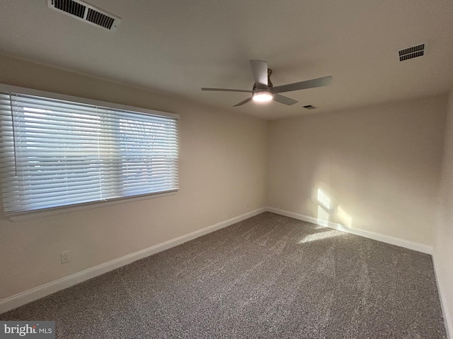 carpeted spare room with ceiling fan