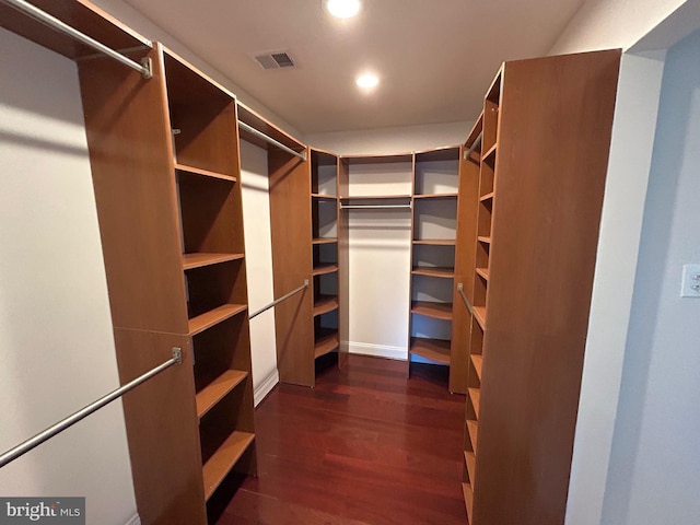 spacious closet with dark hardwood / wood-style floors