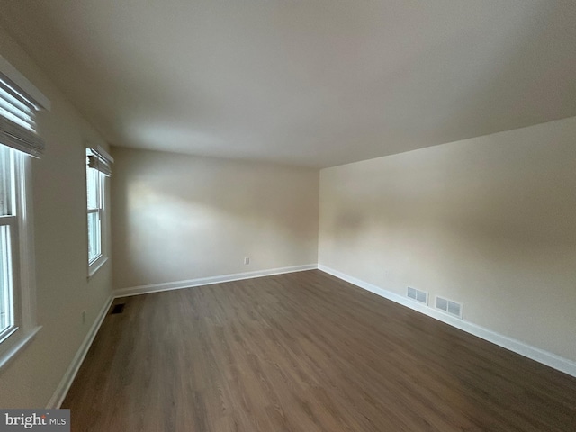 spare room with dark hardwood / wood-style floors