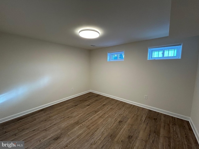 basement with dark wood-type flooring