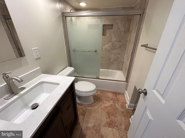 full bathroom with toilet, vanity, and shower / bath combination with glass door