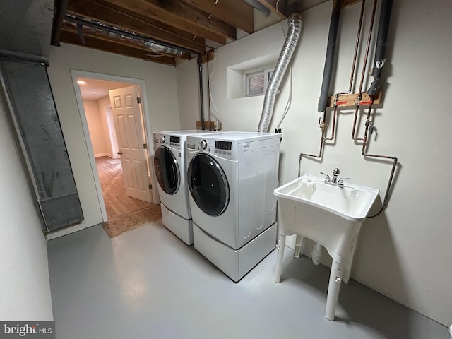 clothes washing area with washer and dryer