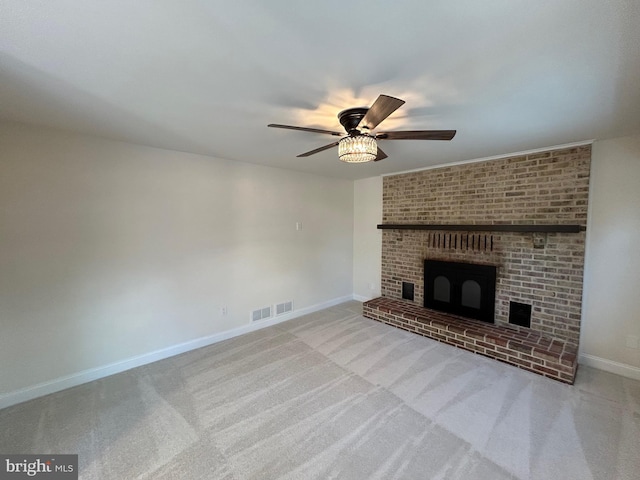 unfurnished living room with ceiling fan, light colored carpet, and a fireplace