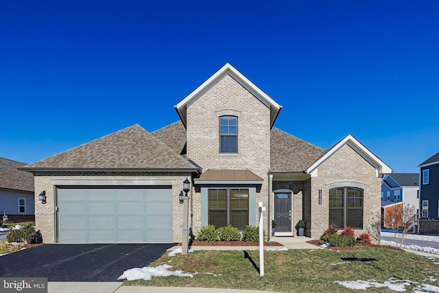 view of front facade with a garage and a front lawn