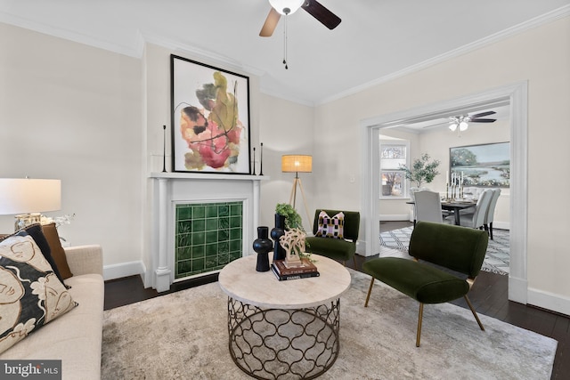 living room featuring ceiling fan, crown molding, and dark hardwood / wood-style floors