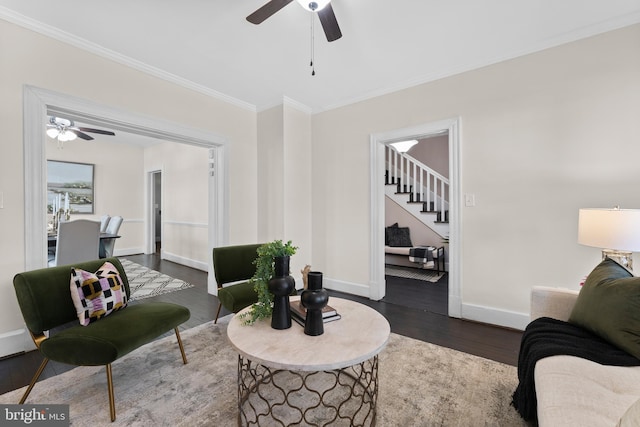 living room with ceiling fan, crown molding, and dark hardwood / wood-style flooring