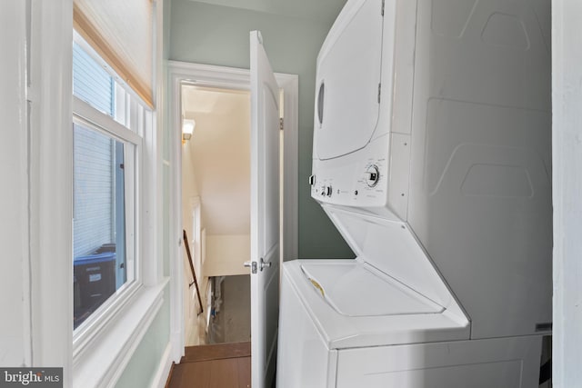 clothes washing area with stacked washer and dryer