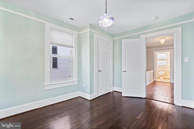 unfurnished bedroom with dark wood-type flooring