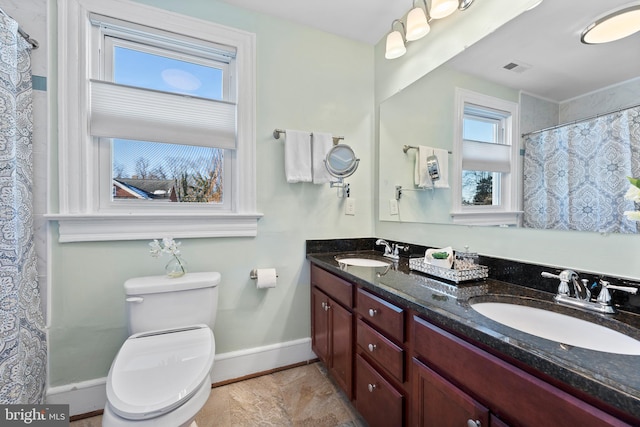 bathroom featuring toilet and vanity