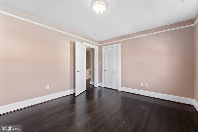 unfurnished room with dark wood-type flooring