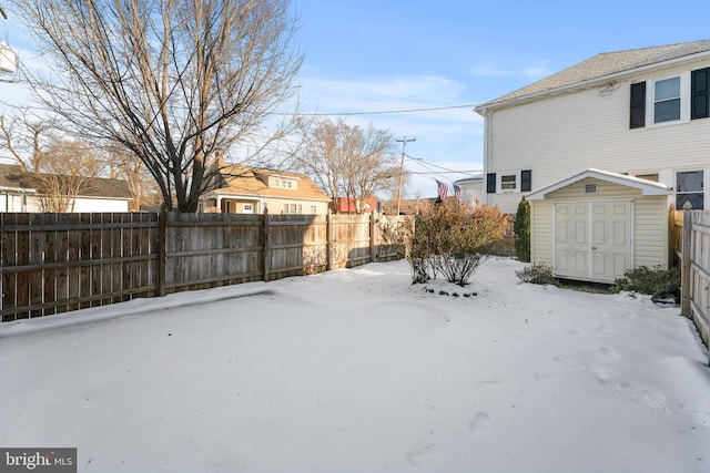 yard covered in snow with a shed