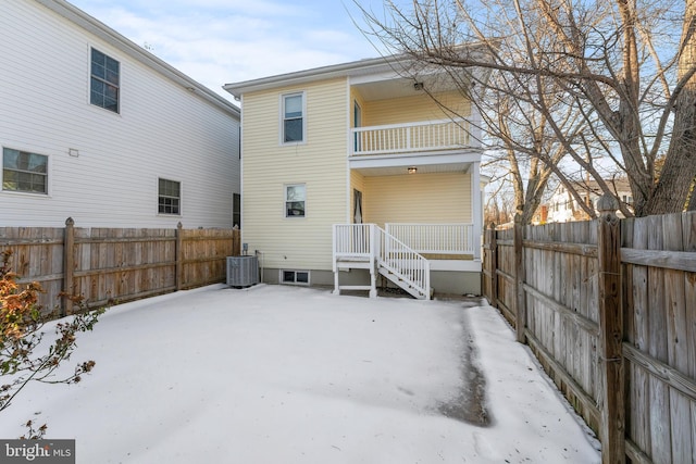 back of property with cooling unit and a balcony