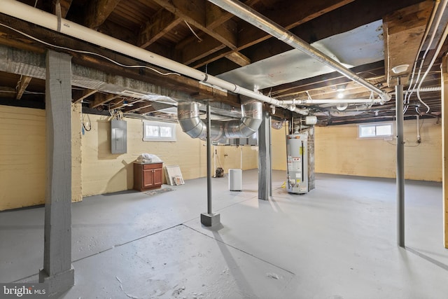 basement featuring gas water heater and electric panel