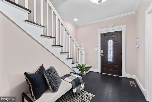 entryway featuring crown molding and dark hardwood / wood-style floors