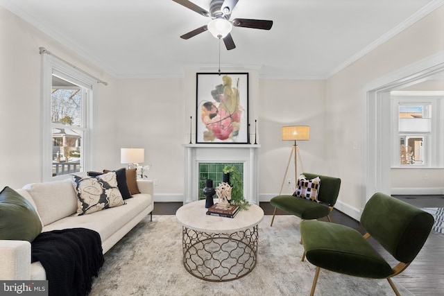 living room featuring ceiling fan, hardwood / wood-style flooring, and crown molding