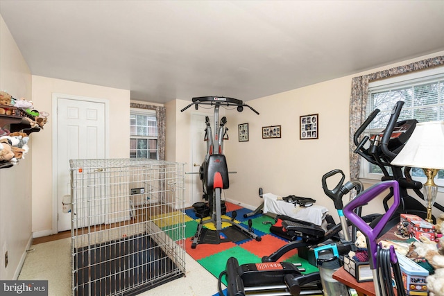 workout room featuring baseboards