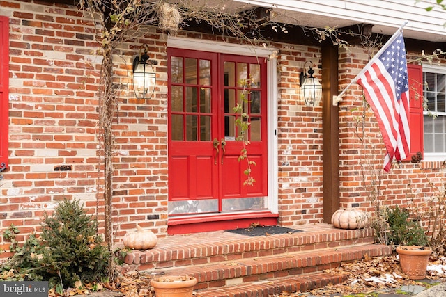 property entrance with french doors and brick siding