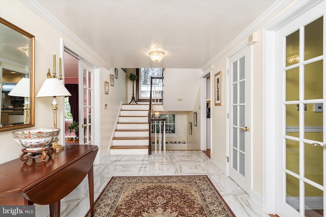 entrance foyer with ornamental molding, marble finish floor, and stairway