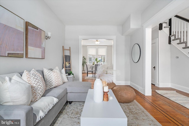 living room featuring ceiling fan and light hardwood / wood-style floors