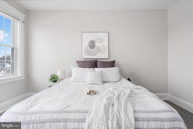 bedroom with carpet flooring and multiple windows