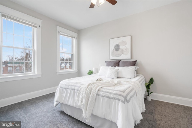 bedroom with ceiling fan and dark colored carpet