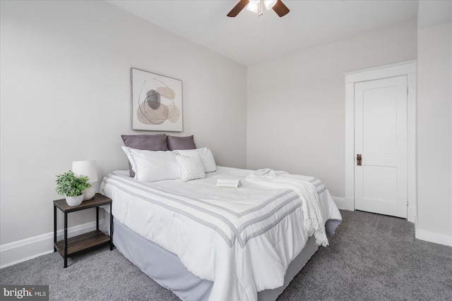 bedroom featuring ceiling fan and dark carpet