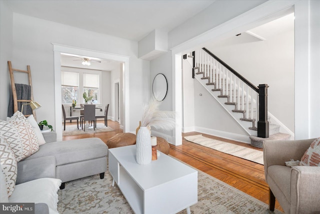 living room with light wood-type flooring and ceiling fan