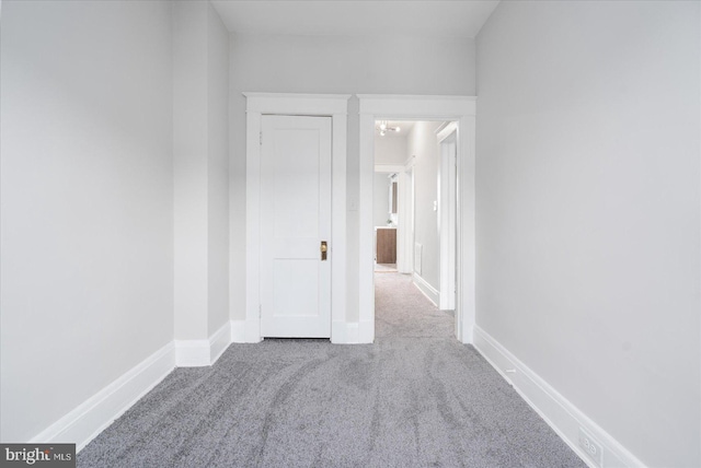 unfurnished room with an inviting chandelier and carpet floors