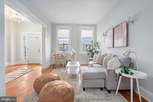 living room featuring light hardwood / wood-style floors and a notable chandelier