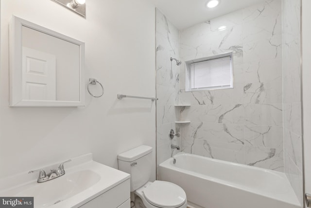 full bathroom with tiled shower / bath combo, toilet, and vanity