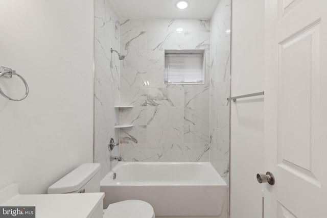 full bathroom featuring toilet, vanity, and tiled shower / bath