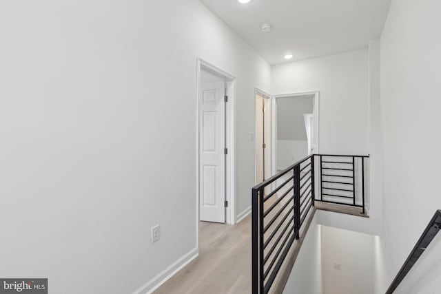 corridor with light hardwood / wood-style flooring