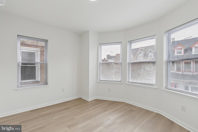 unfurnished room featuring light hardwood / wood-style floors