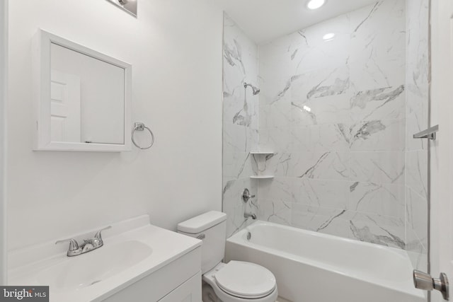 full bathroom with toilet, vanity, and tiled shower / bath