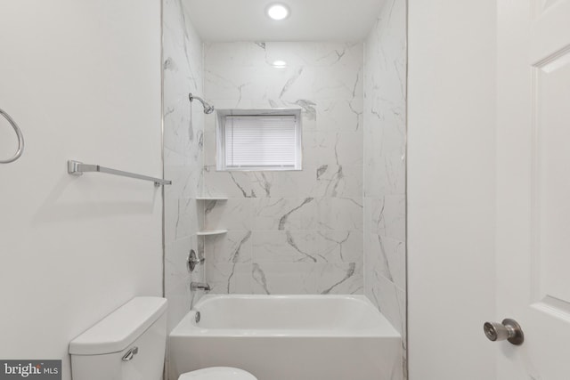 bathroom with toilet and tiled shower / bath combo