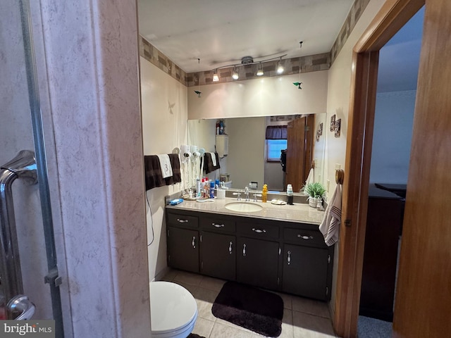 bathroom featuring toilet, vanity, and tile patterned floors