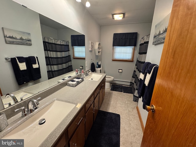 bathroom with toilet, baseboard heating, tile patterned floors, and vanity