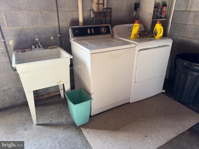 washroom with sink and separate washer and dryer