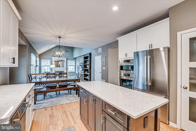 kitchen featuring white cabinets, stainless steel appliances, and a kitchen island