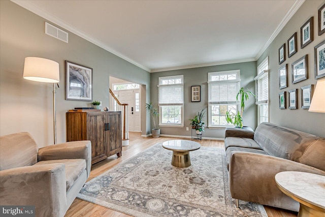 living room featuring light hardwood / wood-style floors and ornamental molding