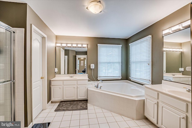 bathroom with independent shower and bath, tile patterned floors, and vanity