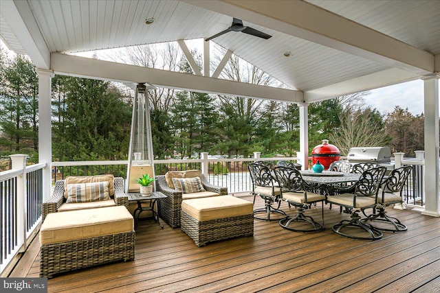 wooden deck with ceiling fan, a water view, a gazebo, and an outdoor hangout area