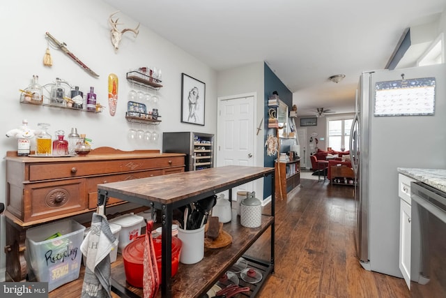 kitchen featuring dark hardwood / wood-style flooring, stainless steel appliances, and ceiling fan