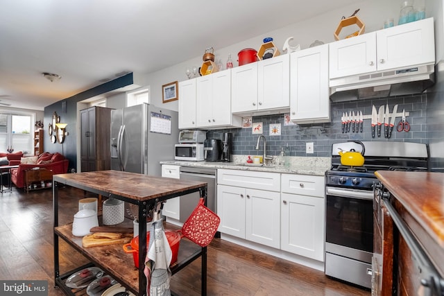 kitchen featuring white cabinetry, stainless steel appliances, and dark wood-type flooring