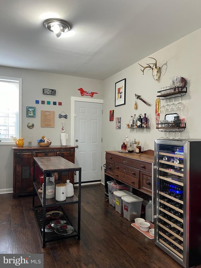 interior space with beverage cooler and dark hardwood / wood-style flooring