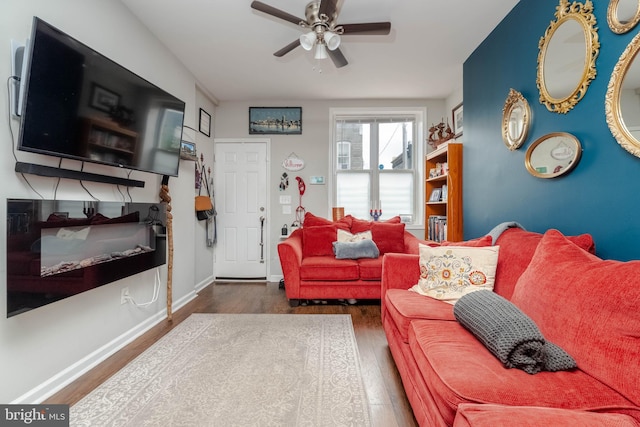 living room with dark hardwood / wood-style floors and ceiling fan