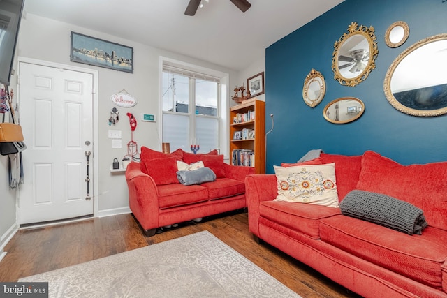 living room with ceiling fan and dark hardwood / wood-style floors