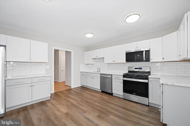 kitchen with appliances with stainless steel finishes and white cabinetry