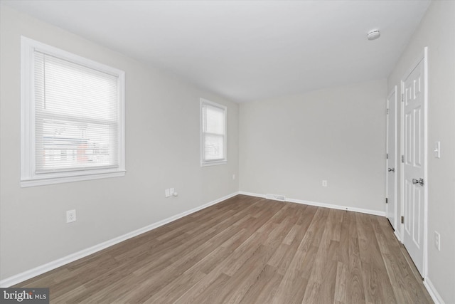 spare room featuring light wood-type flooring