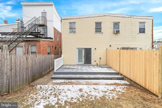 rear view of property with cooling unit and a wooden deck